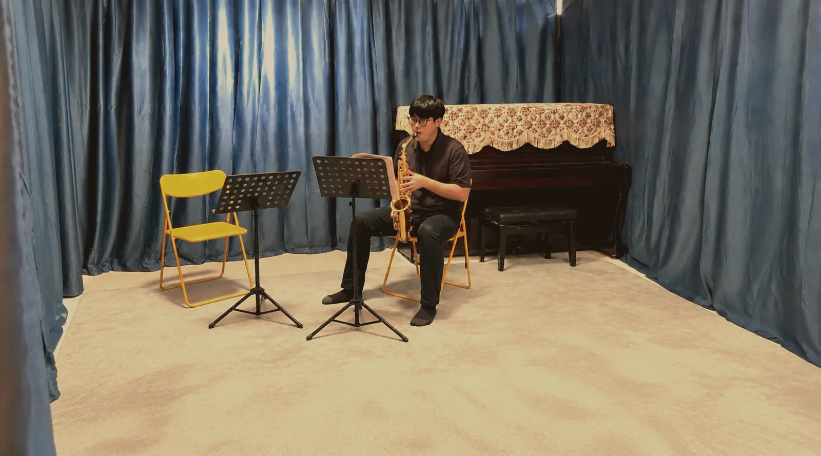 A saxophonist practising alone in the TWA studio
