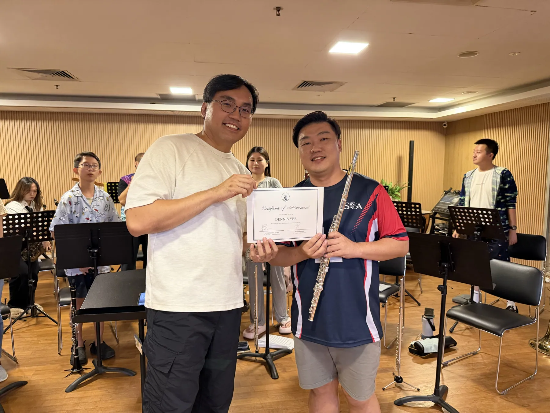 A TWA band member receiving a certificate of achievement at Finale 2026