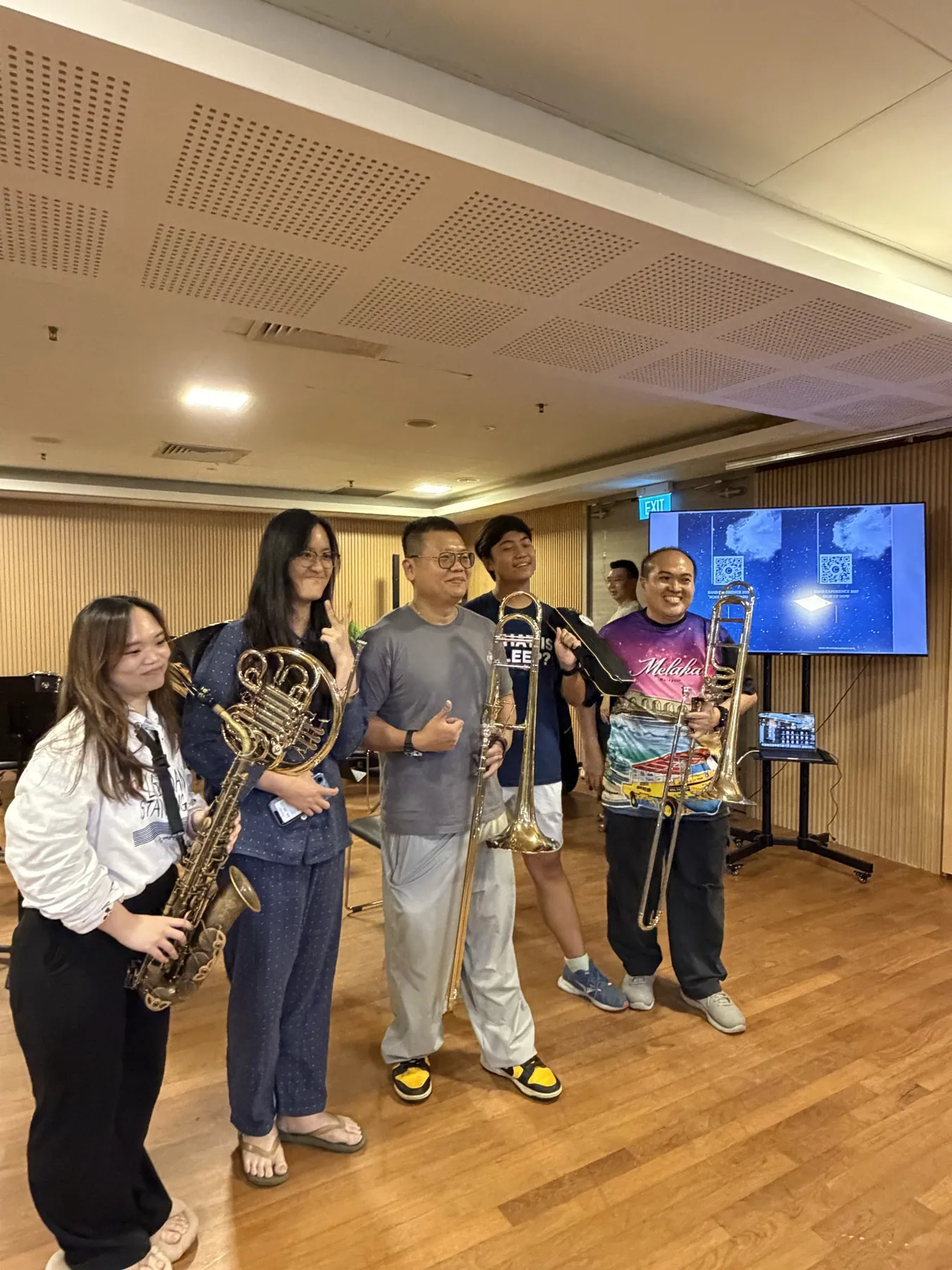 Five TWA band members with their saxophone, horn and trombones after Finale 2026