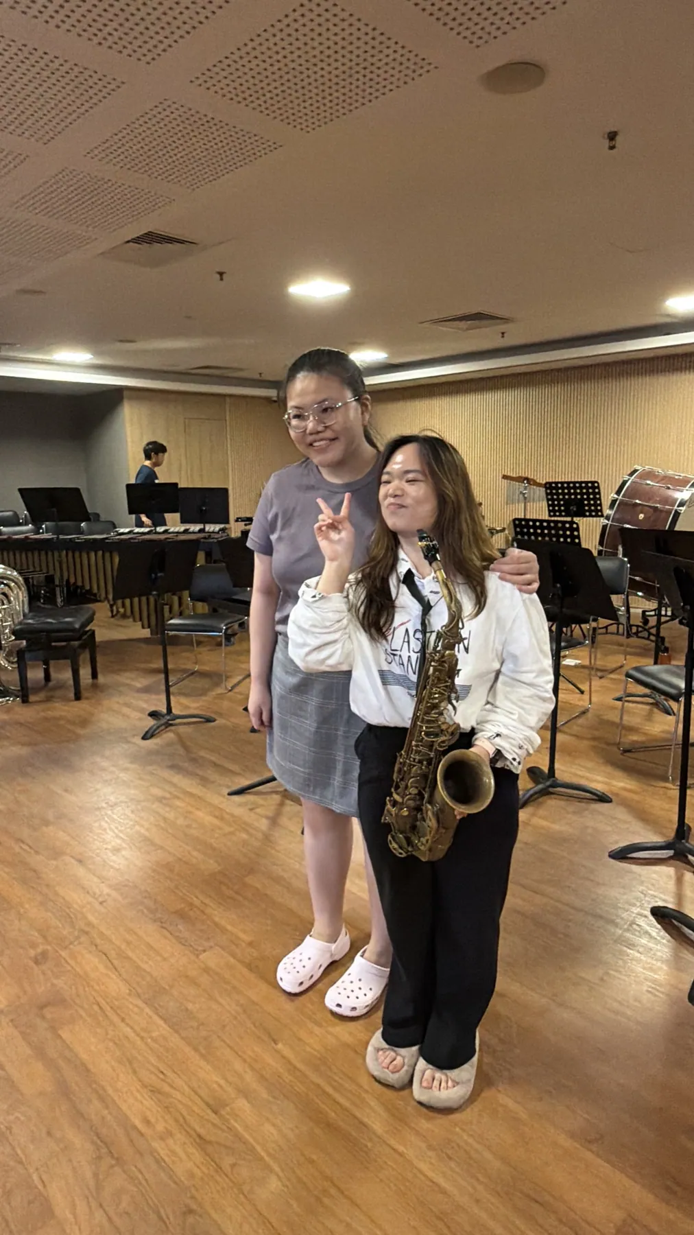 Two friends together after Finale 2026, one holding her saxophone