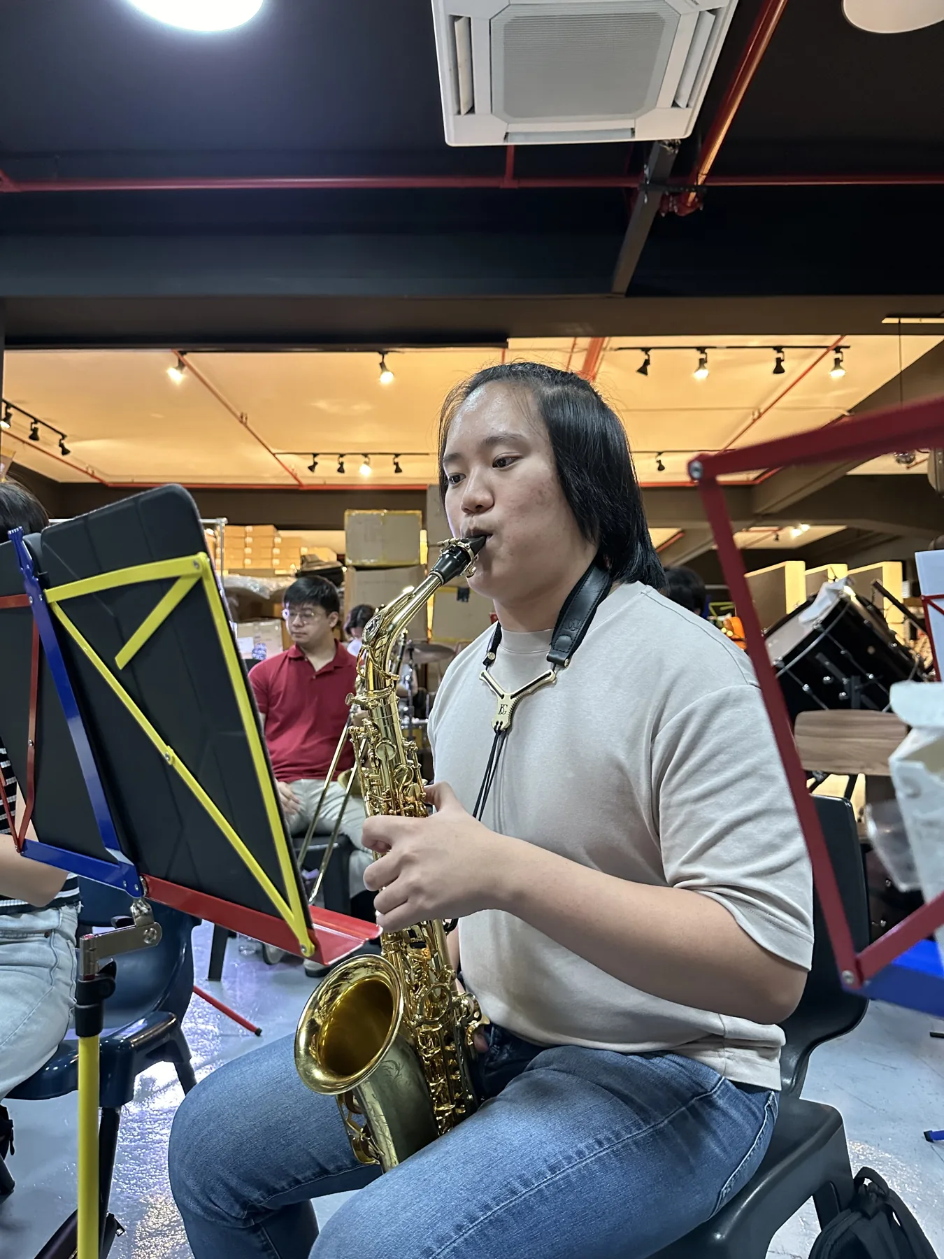 A TWA saxophonist playing at a 2024 band rehearsal