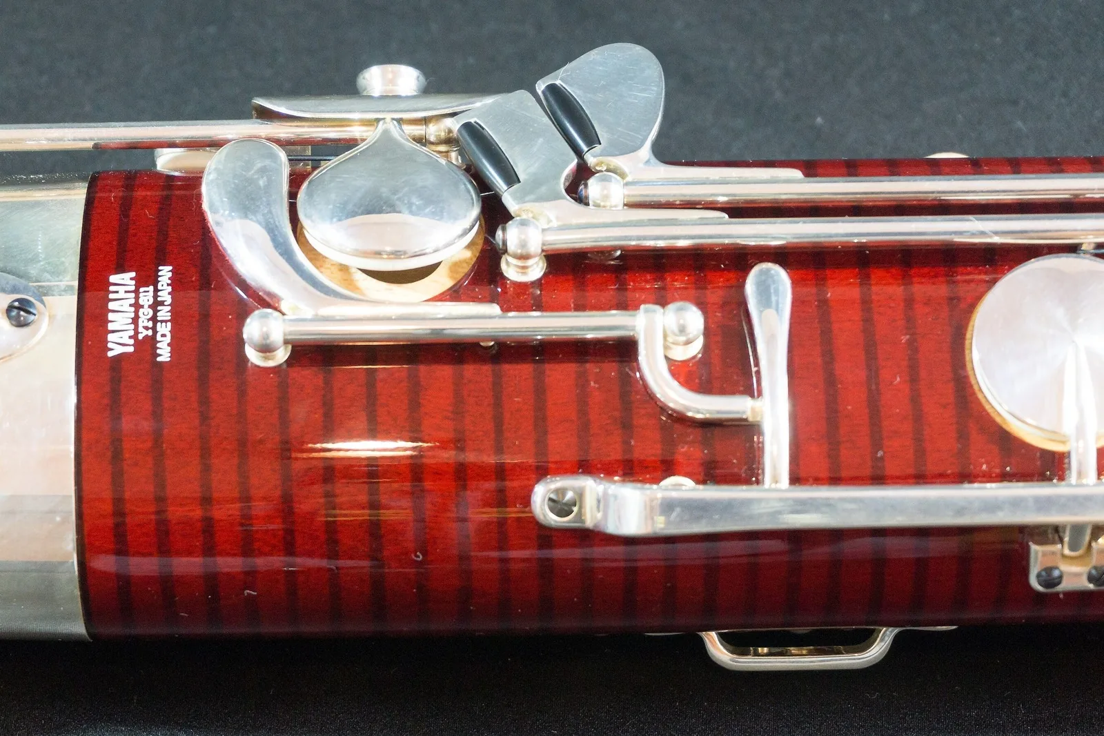 Close-up of the silver keys on a red-brown bassoon