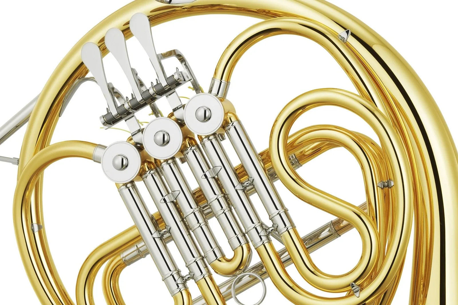 Close-up of the valves and tubing of a brass French horn