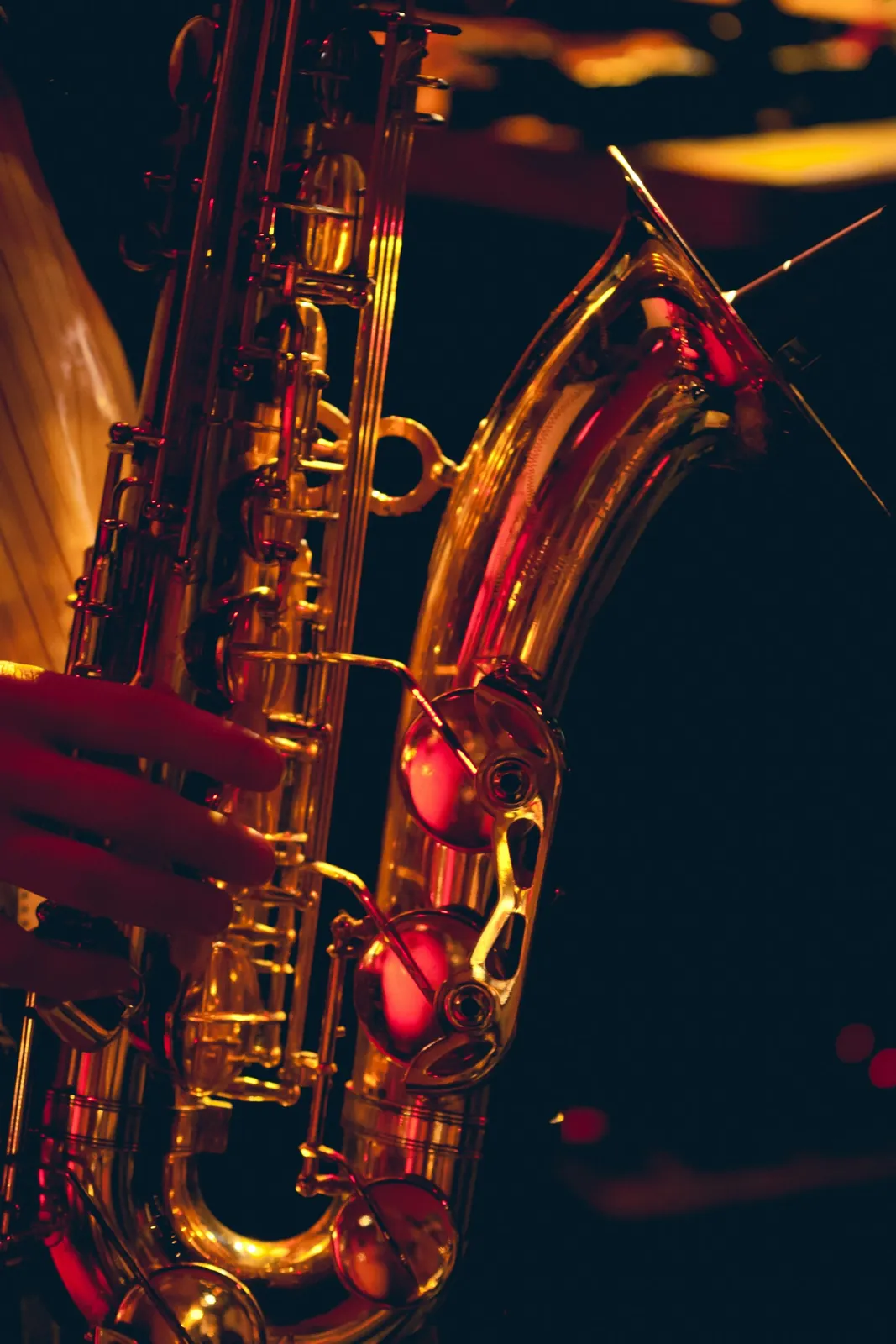 A brass saxophone against a black background