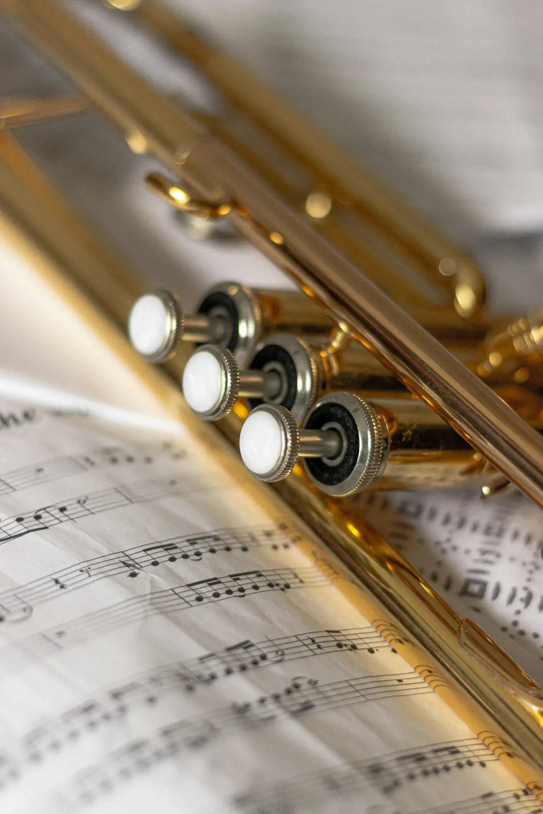 A brass trumpet resting on sheet music