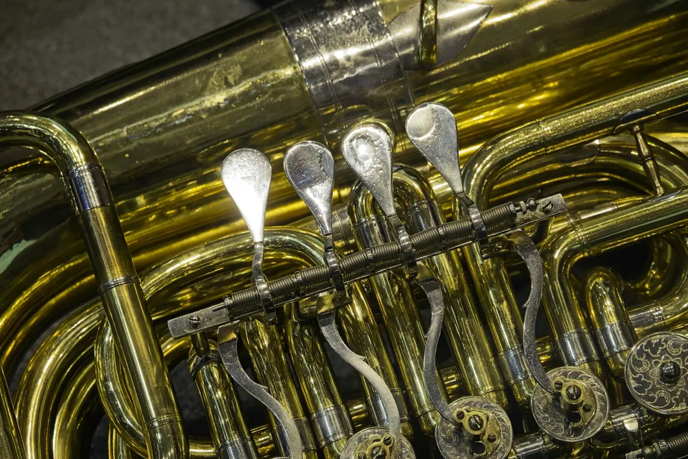 Close-up of the valves and tubing of a brass tuba
