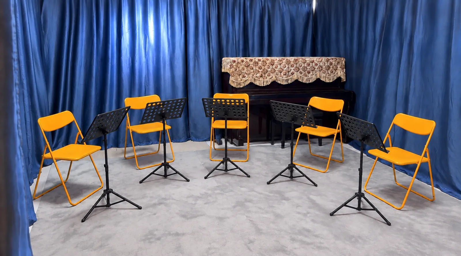 Six chairs and music stands set up for an ensemble rehearsal in the TWA studio