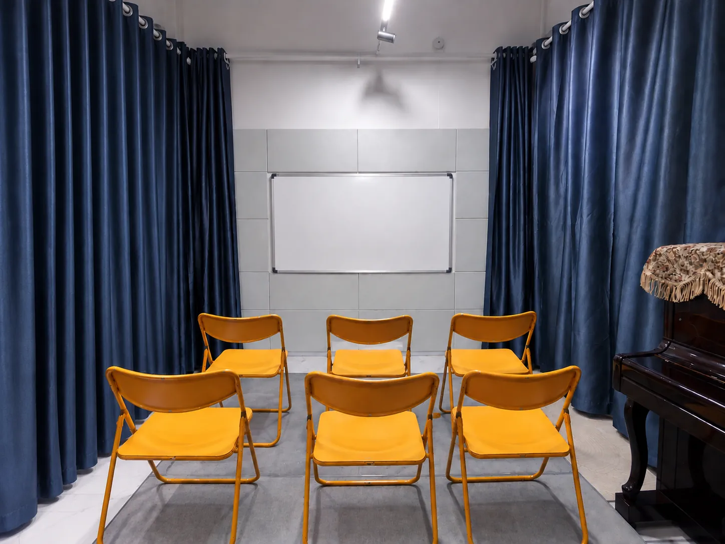 Chairs set out facing the whiteboard for a group class in the TWA studio