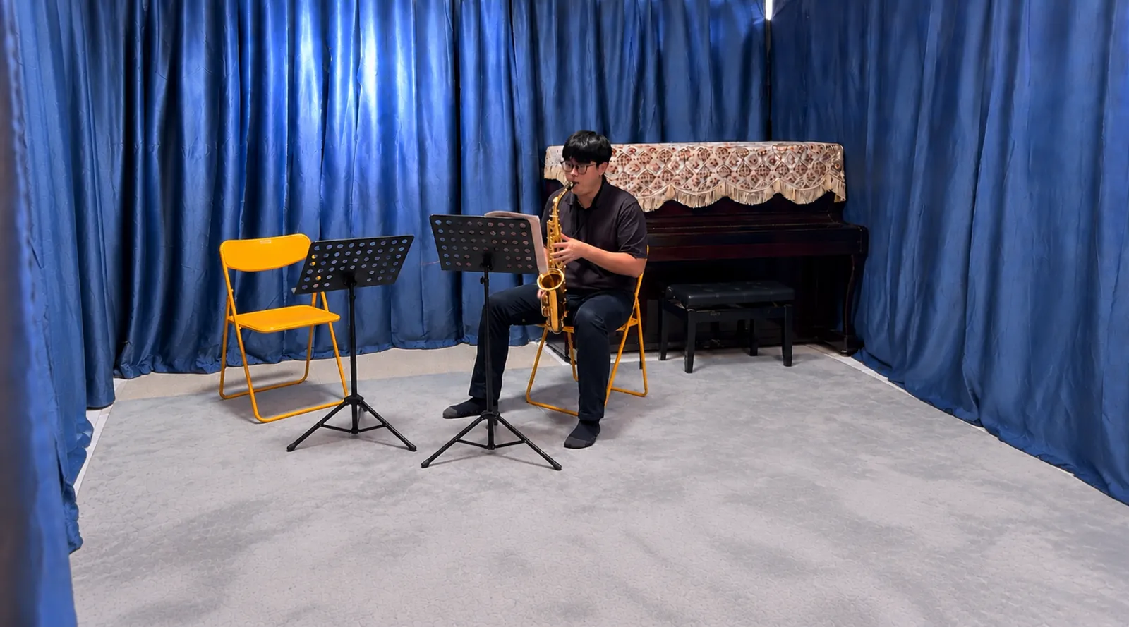A saxophonist practising alone in the TWA studio