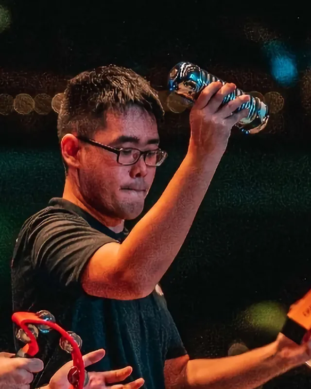 Mark Ang playing percussion on stage