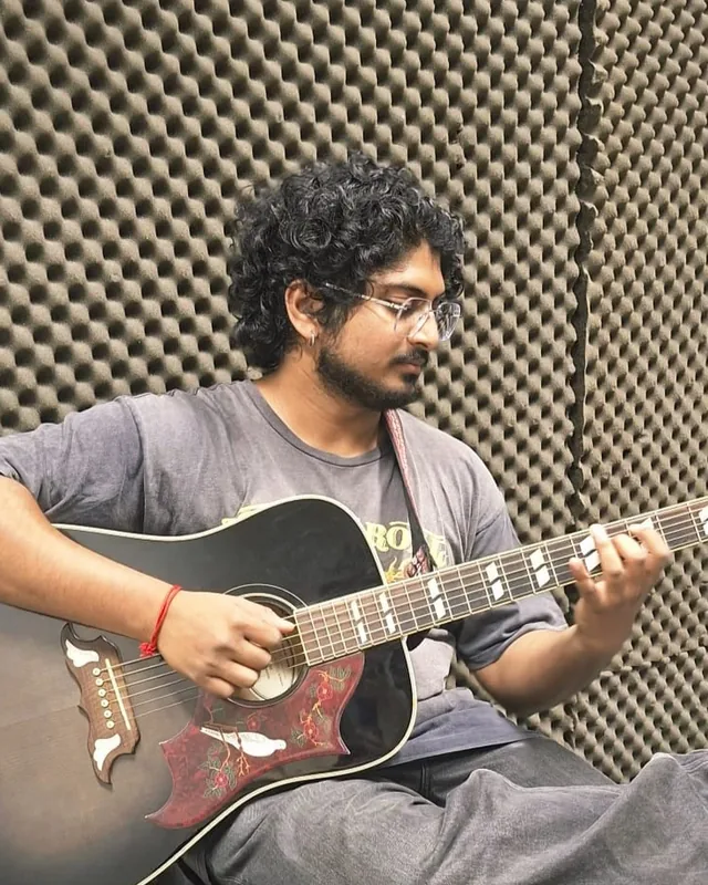 Prasad Siva playing acoustic guitar