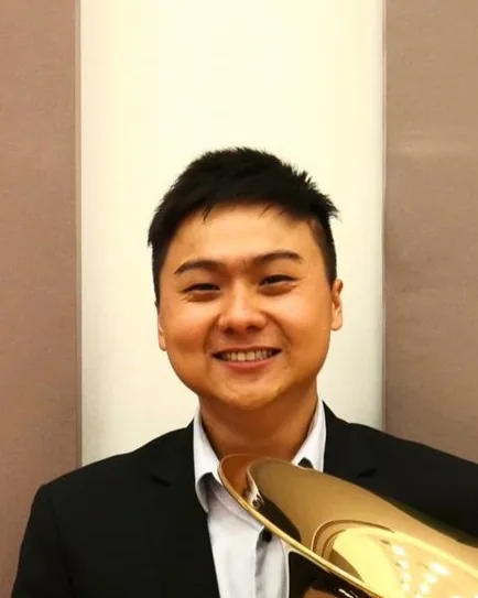 Shawn Yap smiling with his tuba