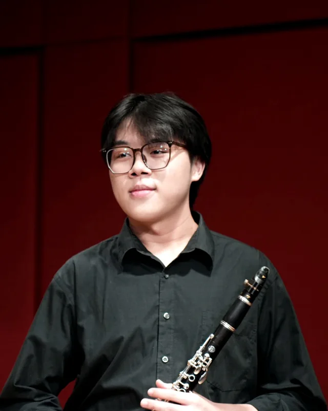 Tan Jing Kai holding his clarinet