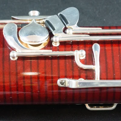 Close-up of the silver keys on a red-brown bassoon