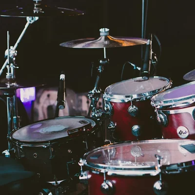 A red drum set with cymbals