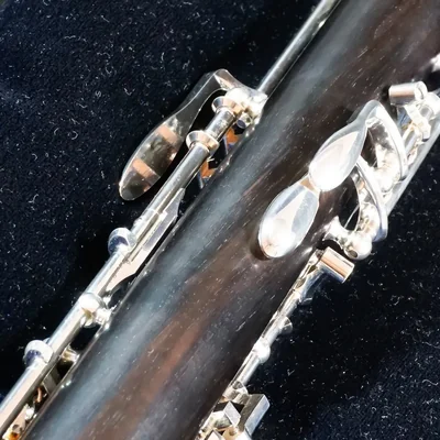 Close-up of the silver keys on a black oboe