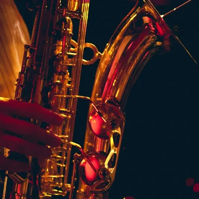 A brass saxophone against a black background