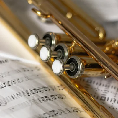 A brass trumpet resting on sheet music
