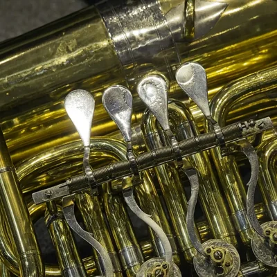 Close-up of the valves and tubing of a brass tuba